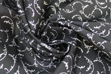 Swirled swatch Silver Whisps fabric (black fabric with tossed silver leafy look wisps allover)