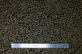Flat swatch Gold Joy fabric (black fabric with collaged "JOY" text allover in gold metallic, text has many different fonts and sizes and goes both horizontally and vertically)