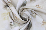 Swirled swatch Leonardo Da Vinci: Faces fabric (white fabric with beige/neutral toned face sketches spaced out)