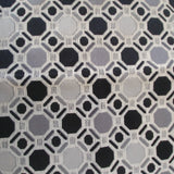 Square swatch upholstery fabric with large and small octagon print with lines and squares connecting all together (white fabric with black/grey octagons)