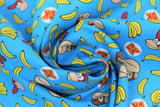 Swirled swatch DK Coordinating fabric (bright blue fabric with tossed yellow single and bunches of bananas, Donkey Kong and Diddy Kong heads, white circular badges with red/yellow DK logo)