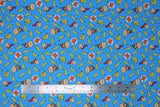 Flat swatch DK Coordinating fabric (bright blue fabric with tossed yellow single and bunches of bananas, Donkey Kong and Diddy Kong heads, white circular badges with red/yellow DK logo)