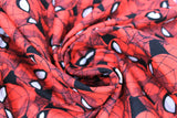 Swirled swatch spider sense fabric (black fabric with large tossed spiderman head, neck and shoulders in various poses/eye shapes)