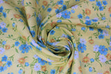 Swirled swatch sunshine toss fabric (pale yellow fabric with small tossed wildflower floral in white, blue, orange floral heads with green stems/leaves)