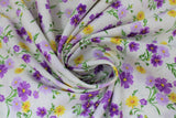 Swirled swatch natural toss fabric (off white fabric with small tossed wildflower floral in white, purple, yellow floral heads with green stems/leaves)