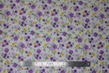 Flat swatch natural toss fabric (off white fabric with small tossed wildflower floral in white, purple, yellow floral heads with green stems/leaves)