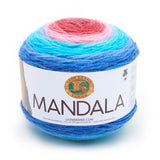 A cake of Lion Brand Mandala yarn in colourway phoenix (medium blue, pale blue, turquoise, baby pink, magenta)