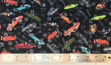 Flat swatch hot rod printed fabric in black (tossed small coloured hot rod cars and tossed grey car emblems wrench, "Hot Rod" text, etc.)