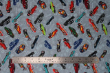 Flat swatch hot rod printed fabric in blue (tossed small coloured hot rod cars and tossed grey car emblems wrench, "Hot Rod" text, etc.)