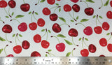 Flat swatch cartoon red and green cherry printed fabric on white