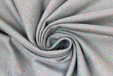 Swirled swatch cotton blend flannel fabric in Speckle (dark grey solid fabric with small tiny flecks/speckles of colour: white, pink, blue, green, red, subtle speckles)