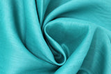 Swirled swatch emerald green linen fabric