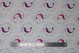 Flat swatch Beautiful Unicorn fabric (white fabric with small closed-eyed drawn style unicorns with pink manes and purple manes outlined in pink, purple, and blue stars and hearts making circle shapes around heads)