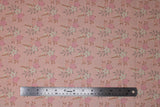Flat swatch Floral fabric (baby pink fabric with repeated floral design allover: whire and pink floral heads with grey and rust coloured leaves)