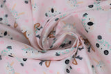 Swirled swatch cartoon animals with flower crowns printed fabric on pale pink (deer, bears, bunny)