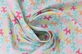 Swirled swatch bright balloon animals fabric (pale blue/turquoise fabric with balloon animal dogs allover in bright rainbow shades)
