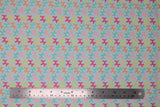 Flat swatch bright balloon animals fabric (pale blue/turquoise fabric with balloon animal dogs allover in bright rainbow shades)
