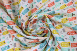 Swirled swatch Townhouse Borough fabric (white fabric with packed illustrative style buildings allover tall style in pink, blue, teal, green and orange)