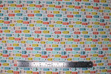 Flat swatch Townhouse Borough fabric (white fabric with packed illustrative style buildings allover tall style in pink, blue, teal, green and orange)