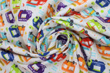 Swirled swatch Food Trucks fabric (white fabric with multicoloured food trucks allover: tacos, guac, churros, etc. in various colours with tossed tacos and chilis etc. in white spaces)