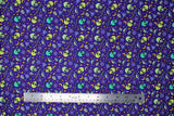 Flat swatch Alien Invasion fabric (bright purple fabric with tossed green shades alien heads and space related emblems allover: UFOs, moons, stars, etc.)