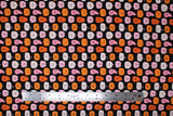Flat swatch Cute Gords fabric (black fabric with neat rows of halloween guords with smiley faces)