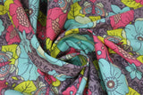 Swirled swatch Aphrodite's Garden fabric (medium grey fabric with dark grey swirly floral pattern background, and large tossed drawn look floral allover in various styles in yellow, blue and pink with tossed decorative butterflies in same colourway)
