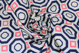 Swirled swatch Sococo fabric (white fabric with concentric navy octagon shapes and pink squares creating alternating geometric pattern allover)