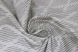 Swirled swatch Harlequin fabric (white fabric with thin black lines making diamond shapes in alternating stripe pattern allover)