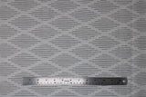 Flat swatch Harlequin fabric (white fabric with thin black lines making diamond shapes in alternating stripe pattern allover)