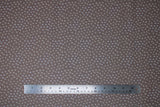 Flat swatch Tonal Cross fabric (grey/brown fabric with small cross/X's allover in grey and pale yellow)