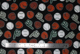 Flat swatch of baseball print fabric on black (black fabric with tossed white baseballs, brown and orange baseball gloves, grey "#1" foam fingers)