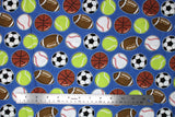 Flat swatch of assorted sports balls fabric on blue (medium blue fabric with small tossed soccer, tennis, baseball, football, basketball)