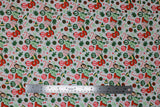 Flat swatch Fa La La La La fabric (white fabric with tossed elf movie related emblems and text allover "Santa" with will character)