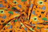 Swirled swatch No Place fabric (orange fabric with tossed cartoon emblems in full colour: black cats, angry apple trees, witch hats, tomb stones, ruby slippers,etc.)
