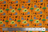Flat swatch No Place fabric (orange fabric with tossed cartoon emblems in full colour: black cats, angry apple trees, witch hats, tomb stones, ruby slippers,etc.)
