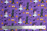 Flat swatch Creepy fabric (purple gingham fabric with tossed black and grey trees, orange jack-o-lanterns, black cats, with Toto and Dorothy characters)