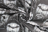 Swirled swatch Batman I am Shadows fabric (black fabric with black and grey batman character behind glowing window with black bat above and grey "I AM THE SHADOWS" text)