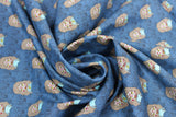 Swirled swatch Regan Peekaboo fabric (blue fabric with regan character heads allover)