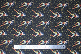 Flat swatch Wonder Woman fabric (black fabric with gold stars and Wonder Woman character tossed allover with golden lasso)