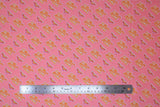 Flat swatch wonder woman retro logo fabric (bubblegum pink fabric with small repeated yellow and pink vintage look W logo and "Wonder Woman" text allover)