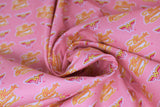 Swirled swatch wonder woman retro logo fabric (bubblegum pink fabric with small repeated yellow and pink vintage look W logo and "Wonder Woman" text allover)