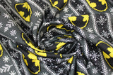 Swirled swatch fair aisle fabric (batman christmas sweater look fabric with black and dark green sweater look stripes and pixelated/knit look yellow and black batman logo)
