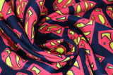Swirled swatch superman logo (black) fabric (black fabric with tossed red and yellow superman logo in various sizes)