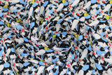 Swirled swatch Sylvester & Tweety fabric (blue fabric with busy repeated pattern of sylvester the cat with tweety bird)