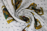 Swirled swatch Hogwarts Houses fabric (white fabric with small grey x's background and tossed full colour hogwarts school crest (all houses))