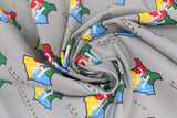 Swirled swatch licensed Harry Potter printed fabric in Hogwarts Crest Gray (multi-coloured logo and text tiled on grey)