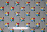 Flat swatch licensed Harry Potter printed fabric in Hogwarts Crest Gray (multi-coloured logo and text tiled on grey)