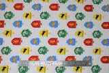 Flat swatch licensed Harry Potter flannel (house crests on white with faint polka dots)