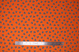 Flat swatch deathly hallows glow fabric (bright orange fabric with small tossed black deathly hallows symbol (triangle with circle and vertical line within) outlined in white tossed allover)